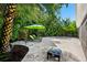 This backyard features lush landscaping, travertine pavers, lounge chairs, and an outdoor grill at 709 Pinewood Dr, Dunedin, FL 34698