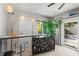 Stylish bar area with unique lighting, modern decor, and easy access to the backyard, perfect for entertaining at 709 Pinewood Dr, Dunedin, FL 34698
