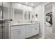 Bright bathroom with double vanity, granite countertops, and decorative mirrors at 709 Pinewood Dr, Dunedin, FL 34698