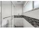 Elegant bathroom showcasing a glass-enclosed shower with tiled walls and modern design elements at 709 Pinewood Dr, Dunedin, FL 34698