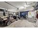 Well-equipped garage featuring a golf cart and a dedicated home gym area at 709 Pinewood Dr, Dunedin, FL 34698