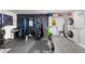 This garage gym has exercise equipment and a washer/dryer at 709 Pinewood Dr, Dunedin, FL 34698