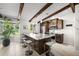 Bright kitchen features stainless steel appliances, granite countertops, and modern bar stools at 709 Pinewood Dr, Dunedin, FL 34698