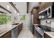 Kitchen featuring stainless steel appliances, granite countertops, and natural lighting at 709 Pinewood Dr, Dunedin, FL 34698