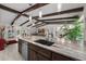 Open-concept kitchen with island, stainless steel appliances, and views into the living area at 709 Pinewood Dr, Dunedin, FL 34698