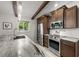 Kitchen featuring stainless steel appliances, granite countertops, and natural lighting at 709 Pinewood Dr, Dunedin, FL 34698