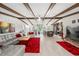 Bright living room with exposed beams, open layout, and access to the modern kitchen at 709 Pinewood Dr, Dunedin, FL 34698