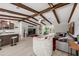 Open-concept living room showcasing beautiful wood beams, light floors, and seamless flow to kitchen and outdoor spaces at 709 Pinewood Dr, Dunedin, FL 34698