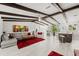 Spacious living room featuring exposed beams, a stone accent wall, and an open floor plan at 709 Pinewood Dr, Dunedin, FL 34698