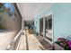 This screened-in patio offers cool blue siding and views of the backyard at 709 Pinewood Dr, Dunedin, FL 34698