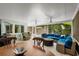 Enclosed patio with comfortable seating, ceiling fans, and views of lush greenery at 709 Pinewood Dr, Dunedin, FL 34698