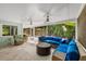 Enclosed outdoor space with comfortable seating, ceiling fans, and a view of the pool area at 709 Pinewood Dr, Dunedin, FL 34698