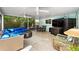 Relaxing screened patio area with tile flooring, comfortable seating, and lush outdoor views at 709 Pinewood Dr, Dunedin, FL 34698