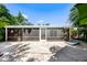 Spacious screened porch with tiled flooring, ideal for outdoor relaxation and entertainment at 709 Pinewood Dr, Dunedin, FL 34698