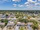 A wide aerial shot showcases the property's location in a peaceful residential neighborhood at 8045 Colton Dr, Port Richey, FL 34668