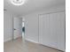 Bedroom featuring wood-look floors and a double-door closet at 8045 Colton Dr, Port Richey, FL 34668