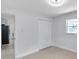 Bedroom featuring wood-look floors and a double-door closet at 8045 Colton Dr, Port Richey, FL 34668