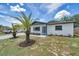 Find curb appeal with new paint, a modern front door, and attractive landscaping around the property at 8045 Colton Dr, Port Richey, FL 34668