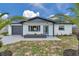 Charming single-story home boasts a freshly painted exterior, neat landscaping, and a modern garage door at 8045 Colton Dr, Port Richey, FL 34668