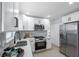 Modern kitchen with stainless appliances, white cabinets, and stylish backsplash at 8045 Colton Dr, Port Richey, FL 34668