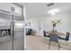 Stainless steel refrigerator and modern kitchen flow into dining area at 8045 Colton Dr, Port Richey, FL 34668