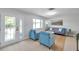 Bright living room featuring a decorative front door, a gray sofa and modern furnishings at 8045 Colton Dr, Port Richey, FL 34668
