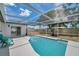 Screened-in pool with an adjacent patio and backyard view at 8045 Colton Dr, Port Richey, FL 34668