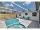 Screened-in pool with an adjacent patio and chairs at 8045 Colton Dr, Port Richey, FL 34668