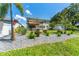 Expansive backyard with a patio, pergola, lush landscaping, and room for outdoor activities at 8050 Praise Dr, Tampa, FL 33625