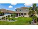 Beautiful backyard featuring a patio with pergola, seating area, and lush landscaping perfect for entertaining at 8050 Praise Dr, Tampa, FL 33625