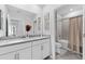 Clean bathroom with dual sinks, bright mirrors and cabinets, a shower-tub combo and bright light at 8050 Praise Dr, Tampa, FL 33625