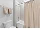A bathroom with white cabinets, chrome fixtures, a tub, shower and warm neutral colors at 8050 Praise Dr, Tampa, FL 33625
