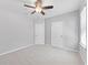 A standard bedroom with light grey walls, ceiling fan and two doors for closet and bathroom access at 8050 Praise Dr, Tampa, FL 33625