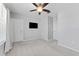This bedroom features a modern ceiling fan and neutral walls. A television is mounted on the wall at 8050 Praise Dr, Tampa, FL 33625