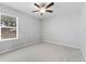 This is a cozy bedroom with neutral carpet and ceiling fan and great light from a window at 8050 Praise Dr, Tampa, FL 33625