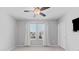 This bedroom features two windows covered with blinds and white curtains, allowing plenty of natural light at 8050 Praise Dr, Tampa, FL 33625