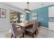 Dining area featuring rustic wooden table, textured blue wall and sliding doors to the patio at 8050 Praise Dr, Tampa, FL 33625
