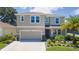 Charming two-story home with a well-maintained lawn, landscaped front yard, and an attached two-car garage at 8050 Praise Dr, Tampa, FL 33625