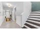 Welcoming foyer features a staircase, white wainscoting and views of the front entry at 8050 Praise Dr, Tampa, FL 33625