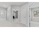 Hallway shows access to bright, carpeted rooms with natural light and modern ceiling fans at 8050 Praise Dr, Tampa, FL 33625