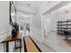 Inviting hallway with modern decor, leading to various rooms with stylish lighting and neutral colors at 8050 Praise Dr, Tampa, FL 33625