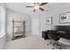 Modern home office with bright lighting, wooden shelves, and a gray carpet. Offers an organized and inviting workspace at 8050 Praise Dr, Tampa, FL 33625