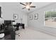Bright office space features a ceiling fan, window, and clean neutral walls for a modern, functional workspace at 8050 Praise Dr, Tampa, FL 33625