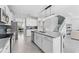 Modern kitchen with white cabinets, stainless steel appliances, and a large center island with bar stools at 8050 Praise Dr, Tampa, FL 33625