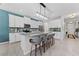 Modern kitchen with white cabinets, a large island with counter seating, and stainless steel appliances at 8050 Praise Dr, Tampa, FL 33625
