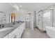 The spacious main bathroom features dual sinks, a walk-in shower with glass door and soaking tub at 8050 Praise Dr, Tampa, FL 33625