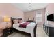 Stylish bedroom features a modern chandelier and a comfortable bed, creating an inviting and tranquil space at 8050 Praise Dr, Tampa, FL 33625