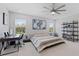This main bedroom offers an ample workspace, natural light from two windows, and sleek ceiling fan at 8050 Praise Dr, Tampa, FL 33625