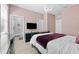 Stylish bedroom features light pink walls, a modern chandelier, and a television at 8050 Praise Dr, Tampa, FL 33625