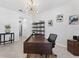 Office with modern desk, decorative shelving, and bright light fixture at 8050 Praise Dr, Tampa, FL 33625